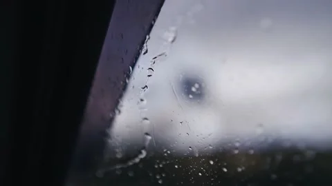 Water drops run down the car window while driving through the rain Stock Footage 153231625