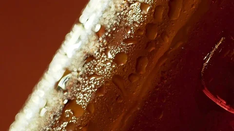 Water drops run down a cooled bottle of cognac Stock Footage 96238993