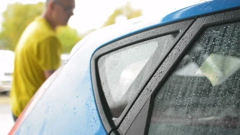 Water drops running down the car windows of just washed new car, self-service 動画素材 110806926