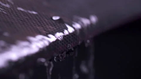Water Drops Running Down Carbon Fiber Stock Footage 154823577