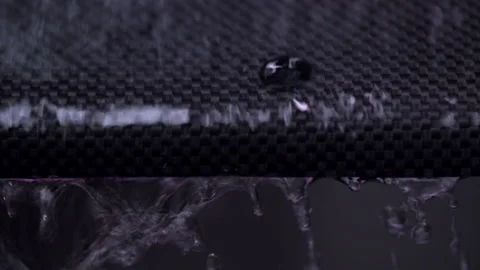Water Drops Running Down Carbon Fiber Stock Footage 154823655