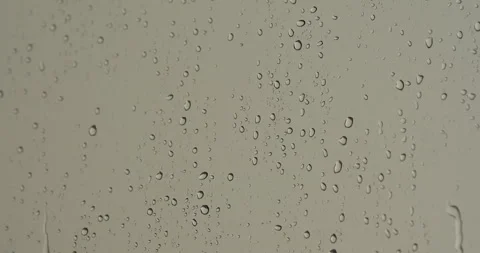 Water drops running down the window glass at rainy day. Close up Stock Footage 257984233