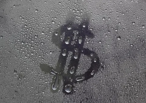 Water drops on silver surface, dollar sign Stock Photos