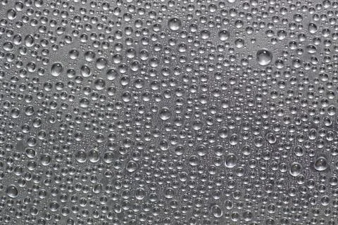 Water drops on silver surface Stock Photos