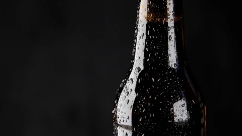 The water drops sliding down the bottle of dark beer Stock Footage 80161803