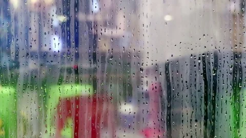 Water drops sliding down on store window glass Stock Footage 70528101