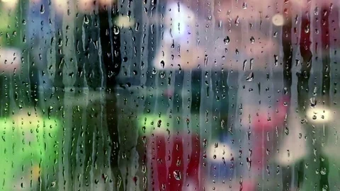 Water drops sliding down on store window glass Stock Footage 70528367