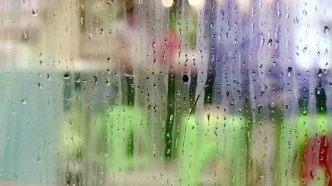 Water drops sliding down on store window glass Stock Footage 70547482