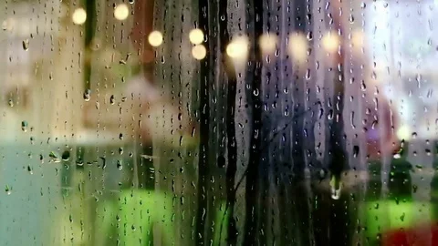 Water drops sliding down on store window glass Stock Footage 70547708