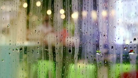 Water drops sliding down on store window glass Stock Footage 70548741