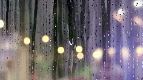 Water drops sliding down on store window glass Stock Footage 70556171