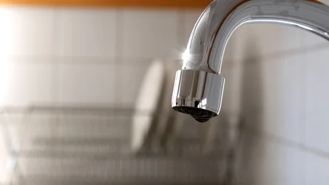 Water drops slowly falling from kitchen tap,  4k Stock Footage 93043525