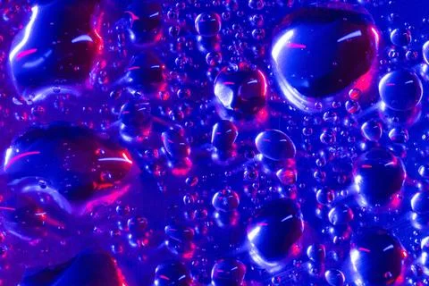 Water drops on a smooth surface, colored background Stock Photos