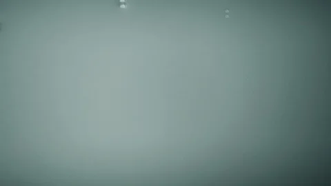 Water drops splashing on a white clear mirrored surface in 4k slow motion Stock Footage 101568584
