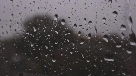 Water drops stream down on window glass after strong rain in detailed close up Stock Footage 163186239