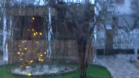 Water drops streaming down glass window in rain, Stock Footage 328639935