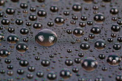 Water drops on surface of screen of cellphone, close-up with selective focus and Stock Photos