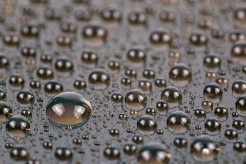 Water drops on surface of screen of cellphone, close-up with selective focus and Stock Photos