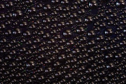 Water drops on surface of screen of modern phone, close-up with selective focus Stock Photos