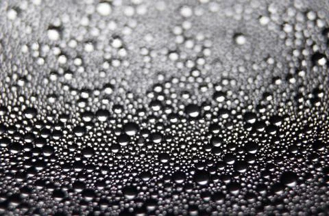 Water drops texture on black background . Stock Photos