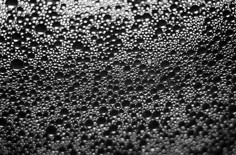 Water drops texture on black background . Stock Photos