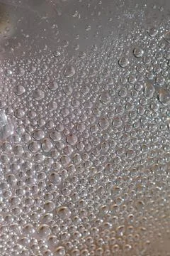 Water drops in transparent bottle close up modern background high quality pri Stock Photos