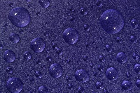 Water drops on violet background Stock Photos