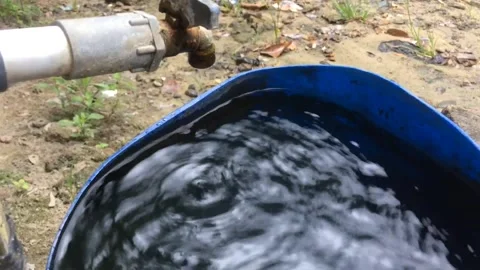 Water drops from the water tap that fall into the reservoir Stock Footage 205512554