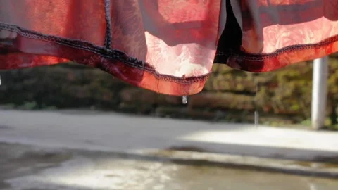 Water drops from wet clothesline Stock Footage 319795634