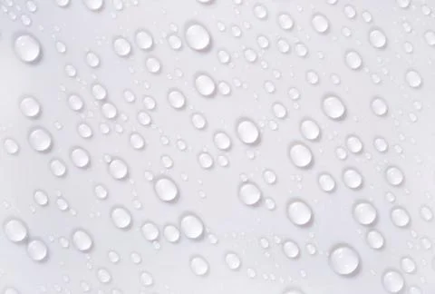 Water drops on the white surface Stock Photos