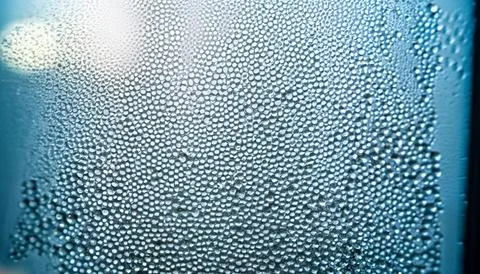 Water drops on the window, close-up. Abstract background. Stock Photos