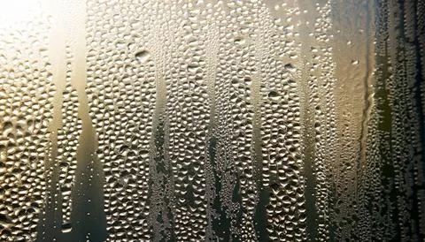 Water drops on the window, close-up. Abstract background. Stock Photos