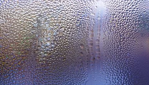 Water drops on the window, close-up. Abstract background. Stock Photos