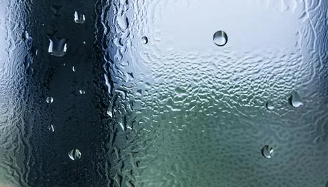 Water drops on the window, close-up. Abstract background. Stock Photos