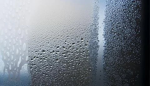 Water drops on the window, close-up. Abstract background. Stock Photos