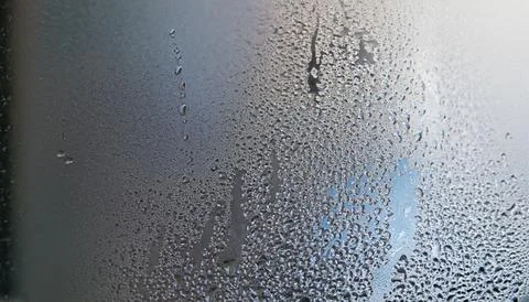 Water drops on the window, close-up. Abstract background. Stock Photos