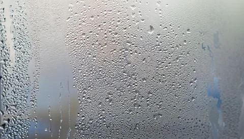 Water drops on the window, close-up. Abstract background. Stock Photos