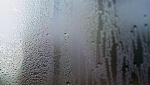 Water drops on the window, close-up. Abstract background. Stock Photos
