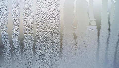 Water drops on the window, close-up. Abstract background. Stock Photos