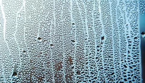 Water drops on the window, close-up. Abstract background. Stock Photos
