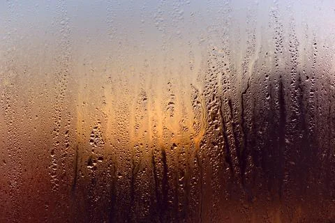 Water drops on a window, on a cold winter morning. Stock Photos