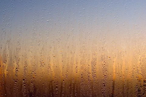 Water drops on a window, on a cold winter morning. Stock Photos