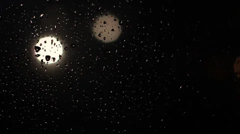 Water drops on window with traffic lights at night. Stock Footage 35603800