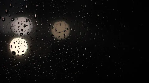Water drops on window with traffic lights at night. Video stock 35603873