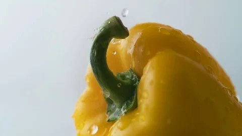 Water drops on yellow pepper. Slow Motion. Stock Footage