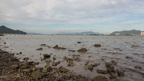 Water escaping from the mud flat and playing people time lapse in Korea Stock Footage 73950086
