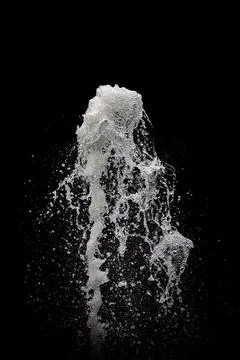 Water exploding into the air with a black background Stock Photos