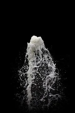 Water exploding into the air with a black background Foto stock
