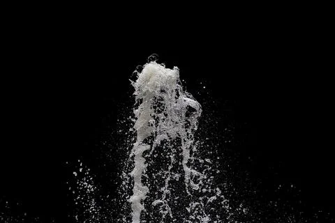 Water exploding into the air with a black background Stock Photos