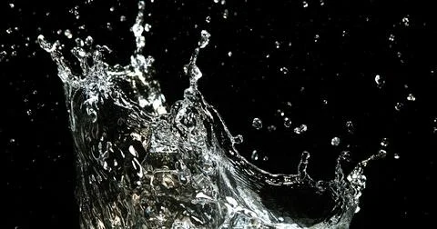 Water Exploding and Splashing against Black Background Stock Photos